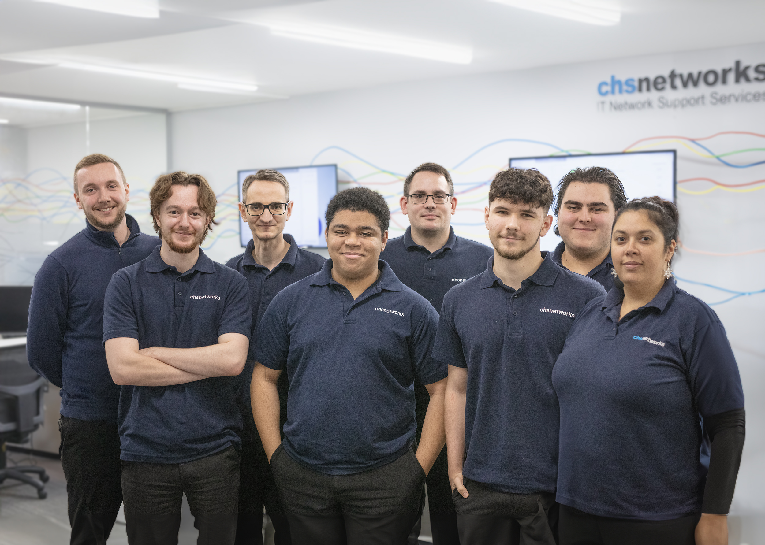 Team photo downstairs with logo CHS Networks